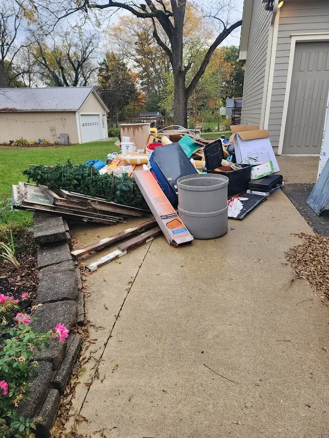 Dumpster being loaded with debris for Residential Dumpster Rental in Oneonta